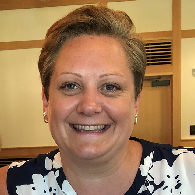 Lacey Ure headshot in a building