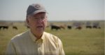 Man talking in cow pasture
