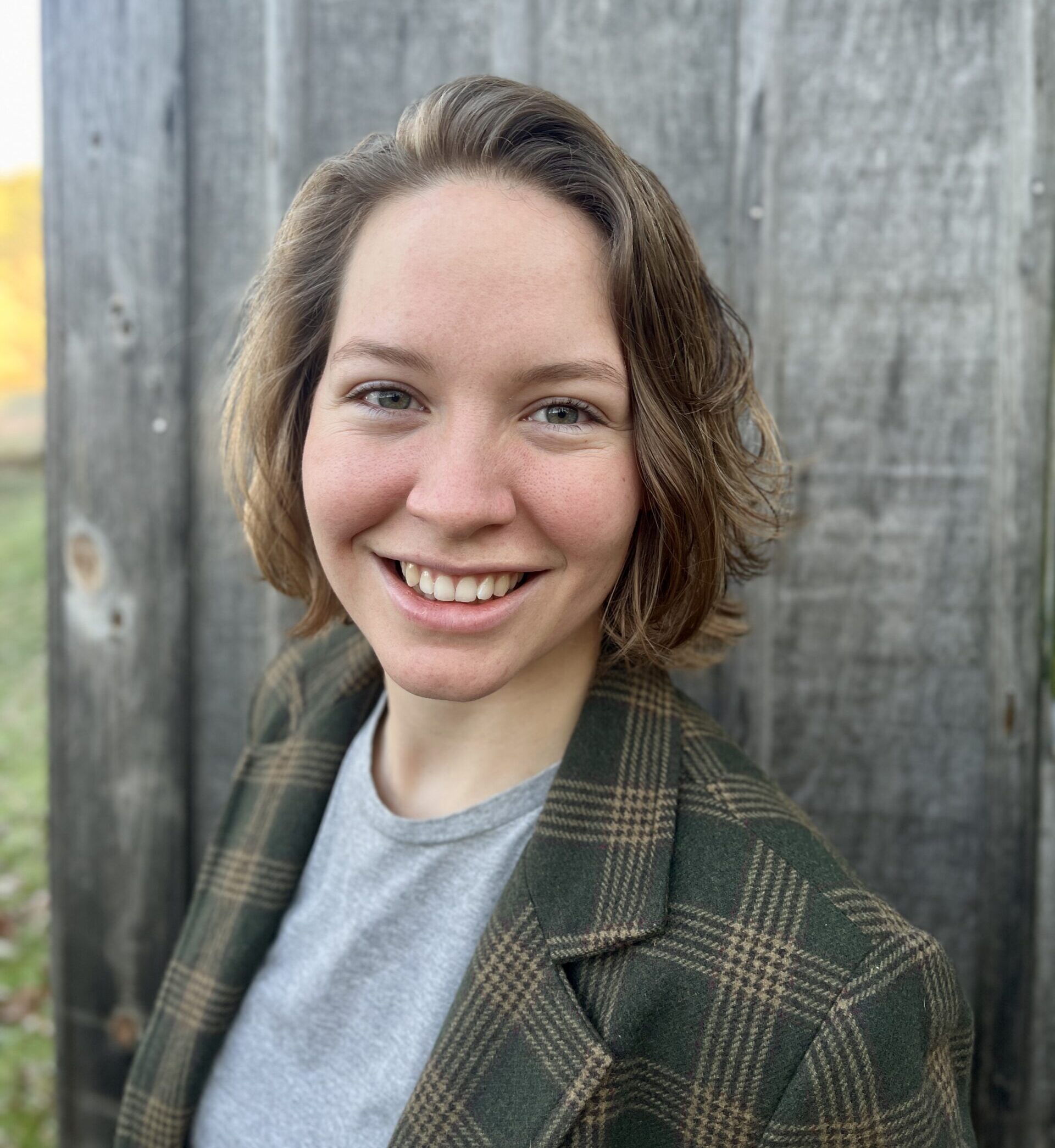 A person with medium length hair smiling
