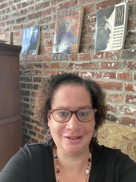 Regional Director Teresa Leslie smiling in front of some art