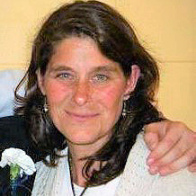 Jennifer Pelkey portrait with another hand around her shoulders