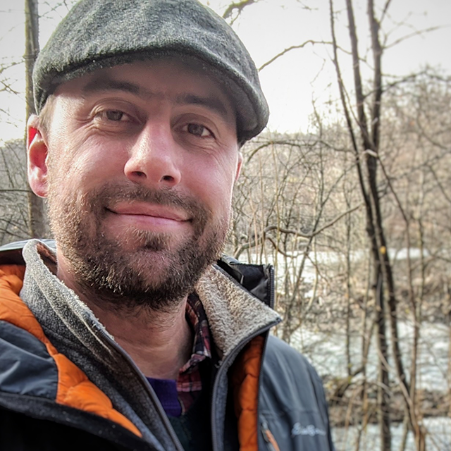 Nevin Dawson self portrait in front of a wintry scene